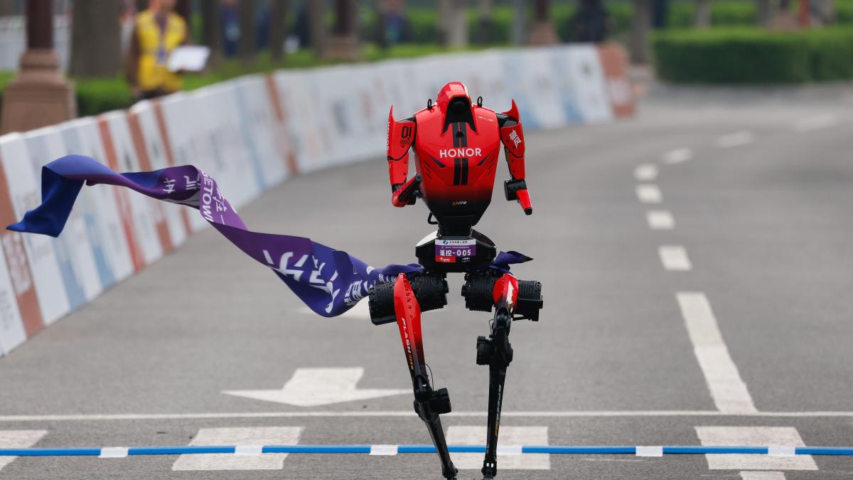 honor red humanoid robot crosses the finish line at the beijing e-town half marathon
