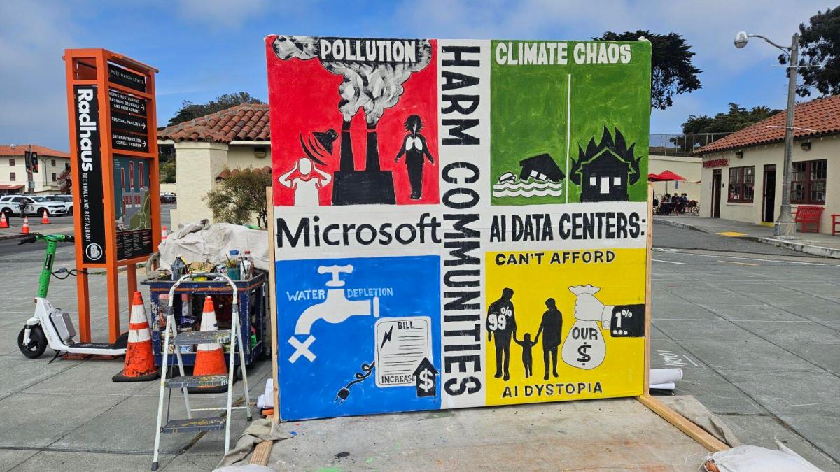 A photo of protest signs about AI data centers during Microsoft Build 2026