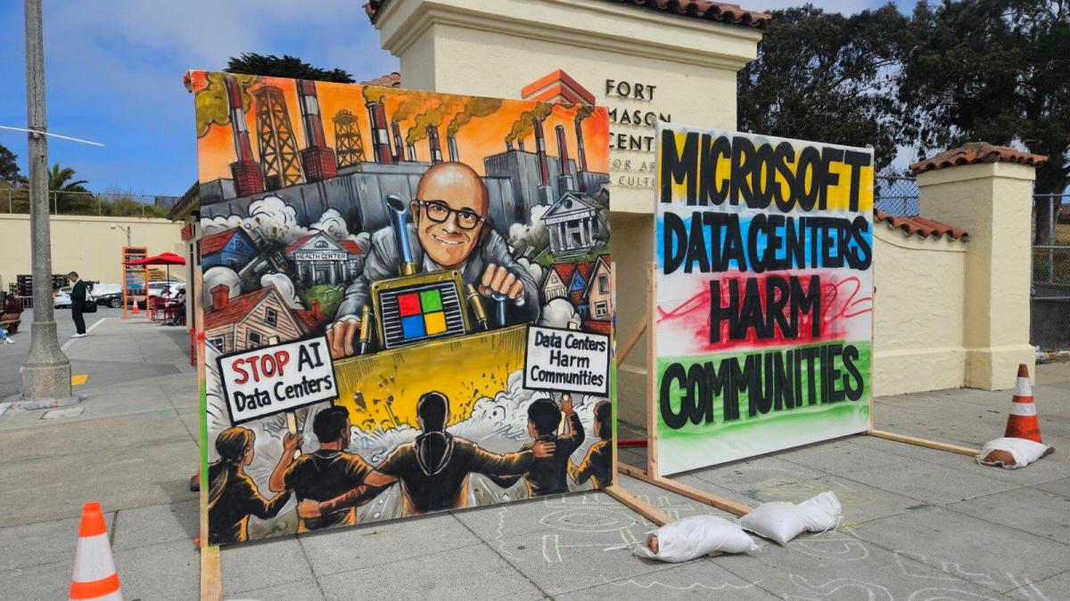 A photo of protest signs about AI data centers during Microsoft Build 2026