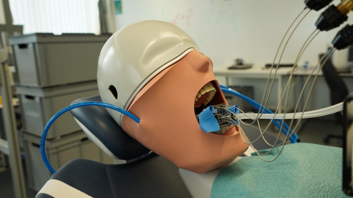 dental robot sits inside the mouth of a dummy patient for testing at the university of basel